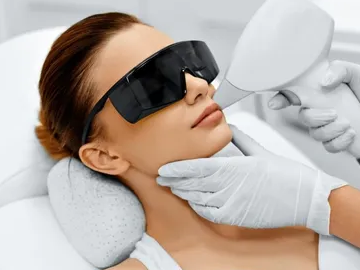 Close-up of laser hair removal being performed on a woman's upper lip.