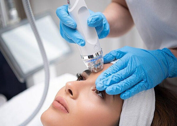 A woman receiving RF microneedling, a skin rejuvenation treatment, at a spa in Mahopac, NY