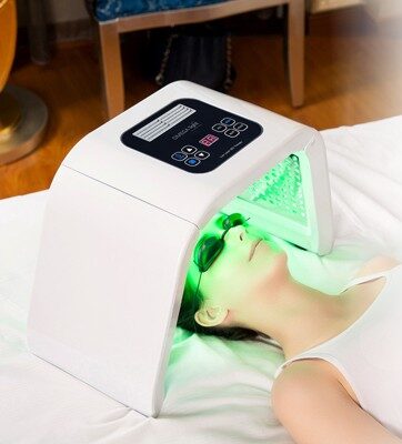 closeup of a female patient undergoing LED mask skin therapy