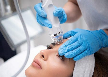 A woman receiving RF microneedling, a skin rejuvenation treatment, at a spa in Mahopac, NY